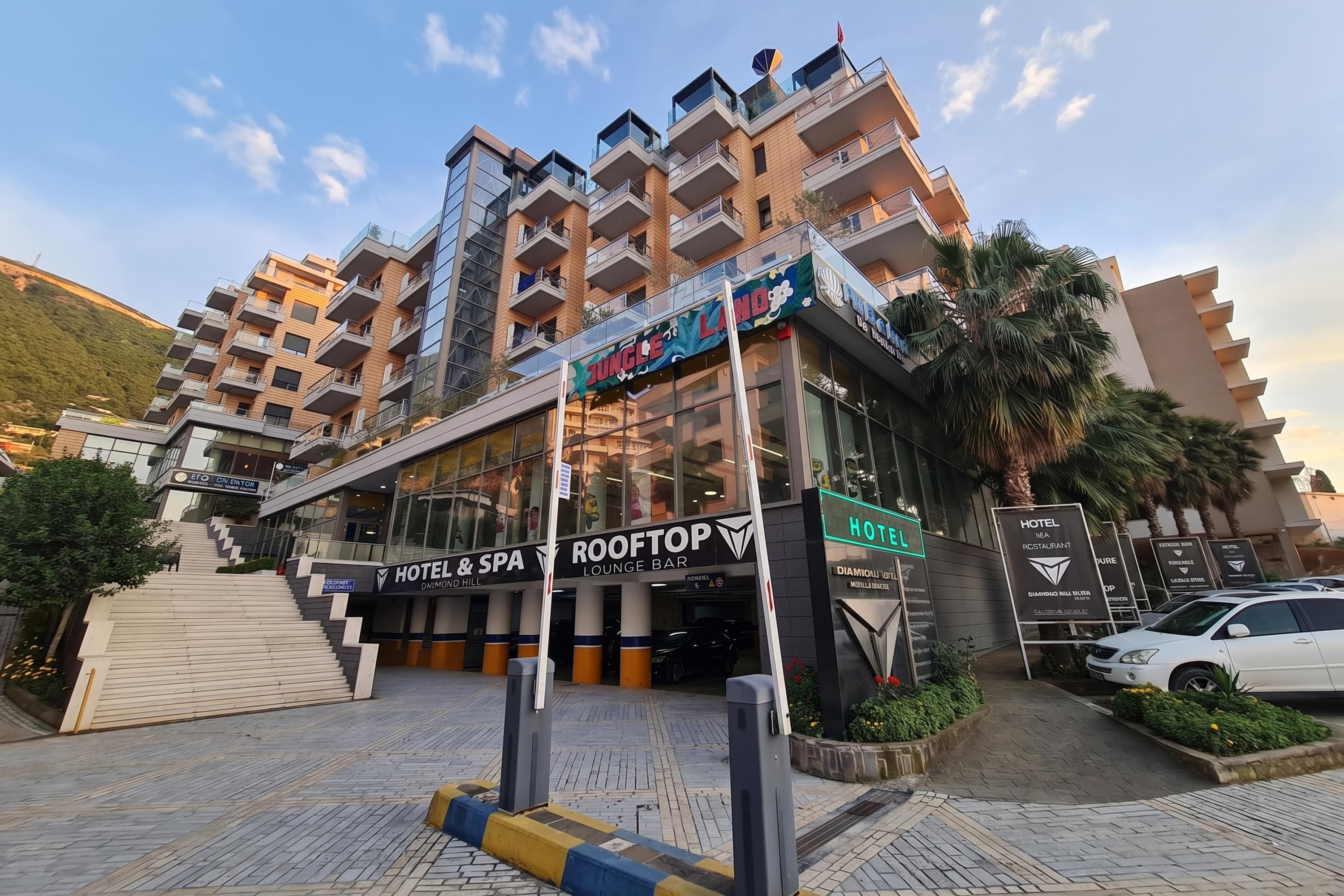 A hotel with a rooftop bar, a sign for a restaurant, and a visible entrance.
