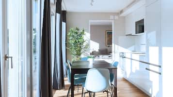 A modern kitchen with white cabinets and a built-in oven.