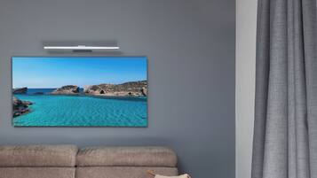Apartment, 1 Double Bed with Sofa bed, Air conditioning, City View | Living area | Flat-screen TV