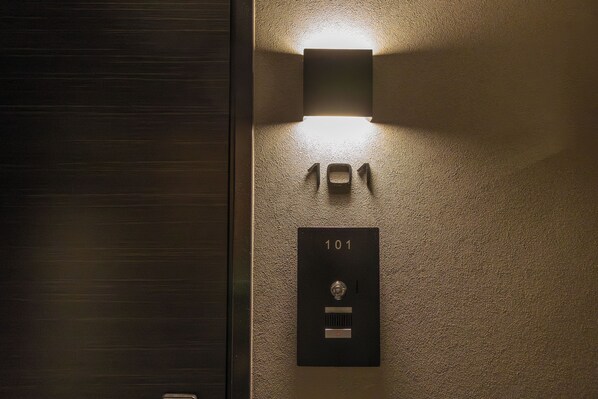 A wall-mounted light fixture above a door with the number '101' indicating a room number. - Rela Kashiwaeki Nishi (Kashiwa)