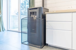 A modern kitchen with a built-in refrigerator, a window with curtains, and a white cabinet. - Gite - 3 bedrooms - sleeps 6 (ROBELMONT)