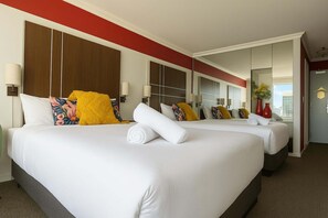 A hotel room with two beds, a large mirror, and a view of the city. - L22 Ocean View 2 Beds Wi-Fi Netflix (Surfers Paradise)