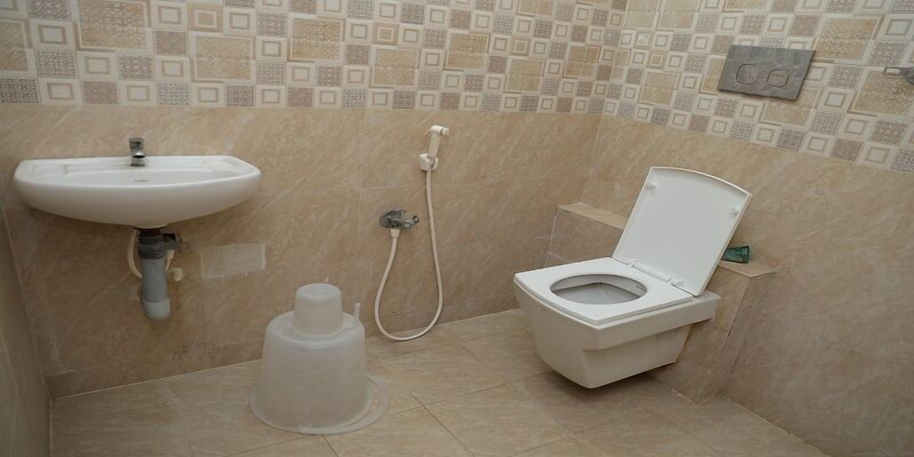 A bathroom with a sink, toilet, and shower.