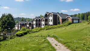 A modern residential building with a stepped design, multiple balconies, and a pathway leading to the entrance. - 4 Person Holiday Park Home in Dienstweiler (Oberhambach)