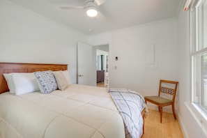 A bedroom with a bed, a chair, a ceiling fan, and a window. - Dock Access! Family Retreat on the Little Wicomico (Heathsville)