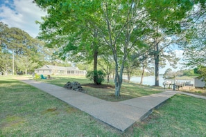 A residential property with a paved driveway, a small lawn, and a lake in the background. - Dock Access! Family Retreat on the Little Wicomico (Heathsville)