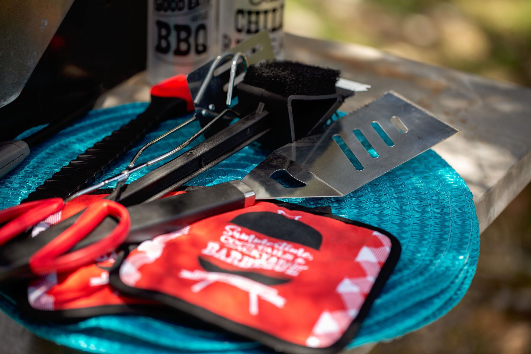 A set of barbecue tools on a blue plate.