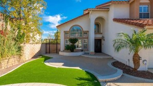 A two-story house with a curved driveway, a well-maintained lawn, and a palm tree. - Marbella Lane - Revitalizing Getaway w Pool (Rowland Heights)
