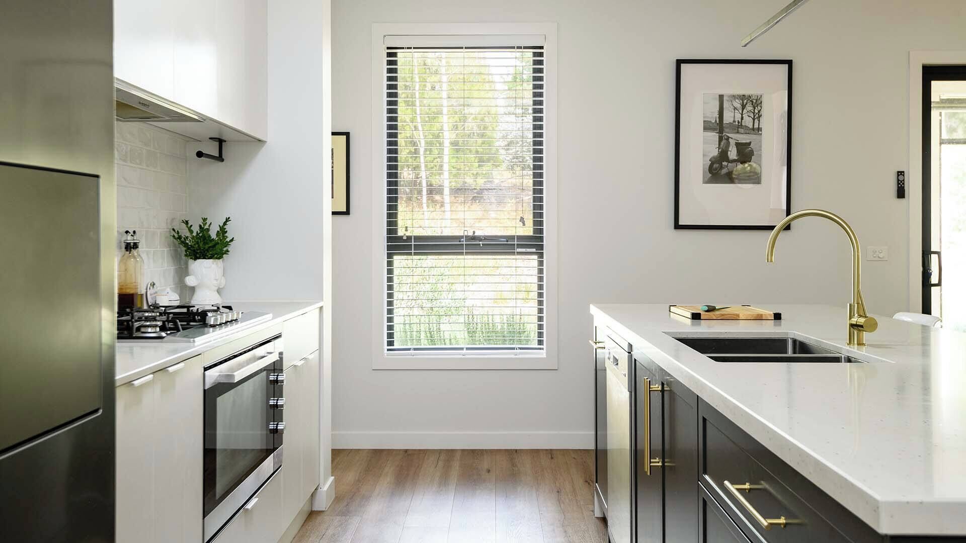 A modern kitchen with a gas stove, oven, and stainless steel appliances.