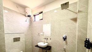 A bathroom with a toilet, sink, and shower. - The Rainbow Villa (Udaipur)
