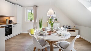 A modern kitchen with white cabinets, a wooden countertop, and a built-in oven. - Nordic Stay Bäk: Private Terrace & Garden near Lake Ratzeburg, Lübeck, Mölln (Bäk)