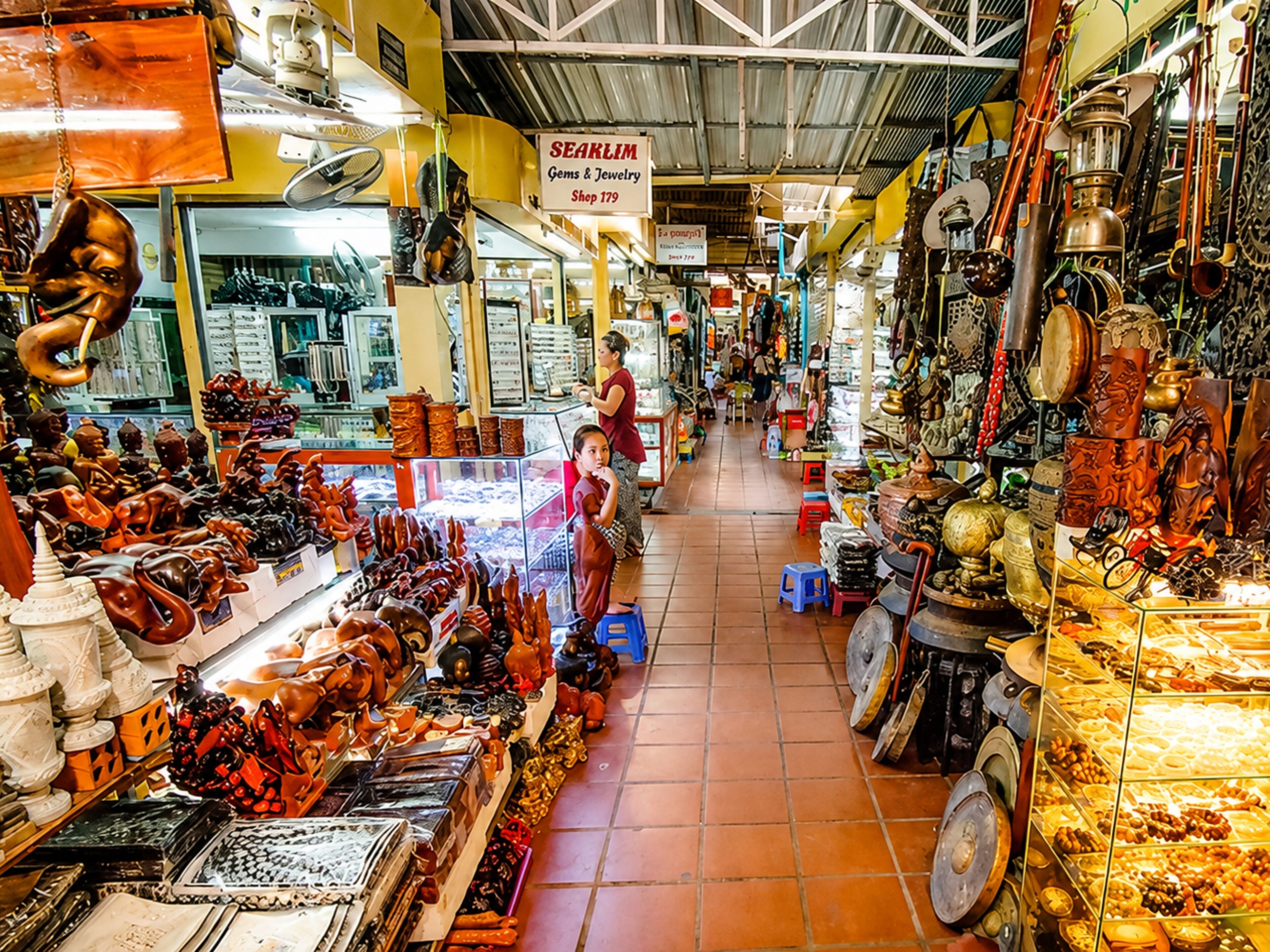 A market with various stalls selling jewelry and decorative items.