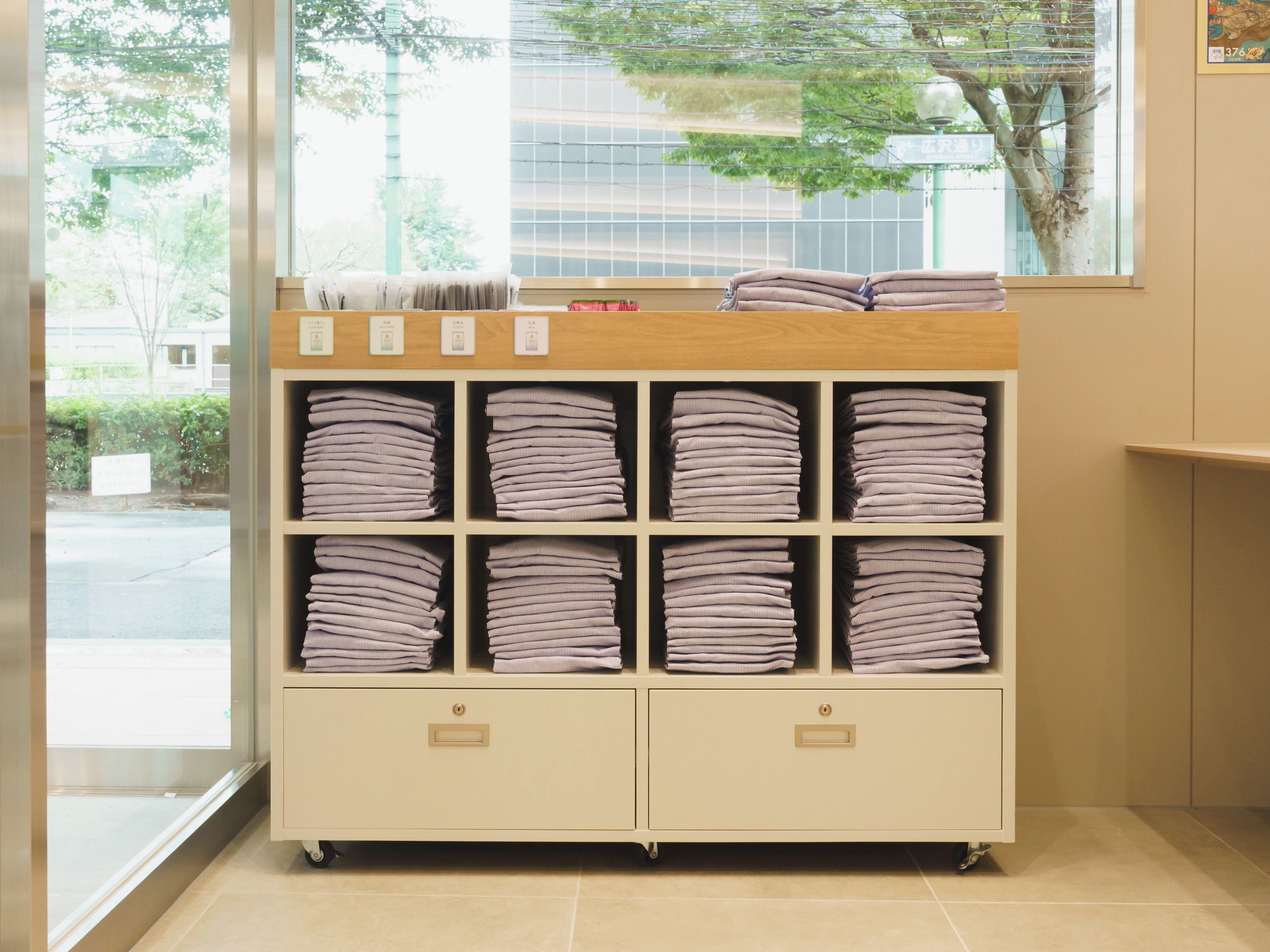 A storage unit with multiple shelves containing folded towels.