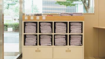 A storage unit with multiple shelves containing folded towels.