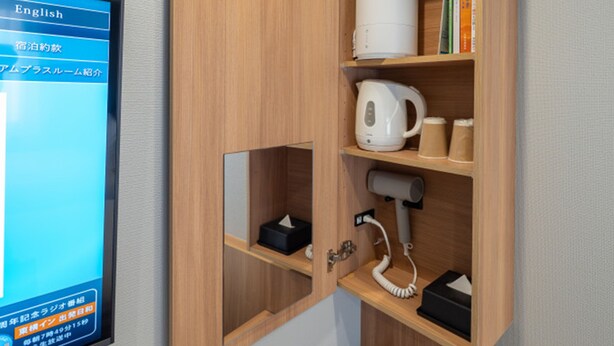 A wooden cabinet with a white kettle, a coffee maker, and a telephone. - Toyoko Inn Tsukuba-eki (Tsukuba)