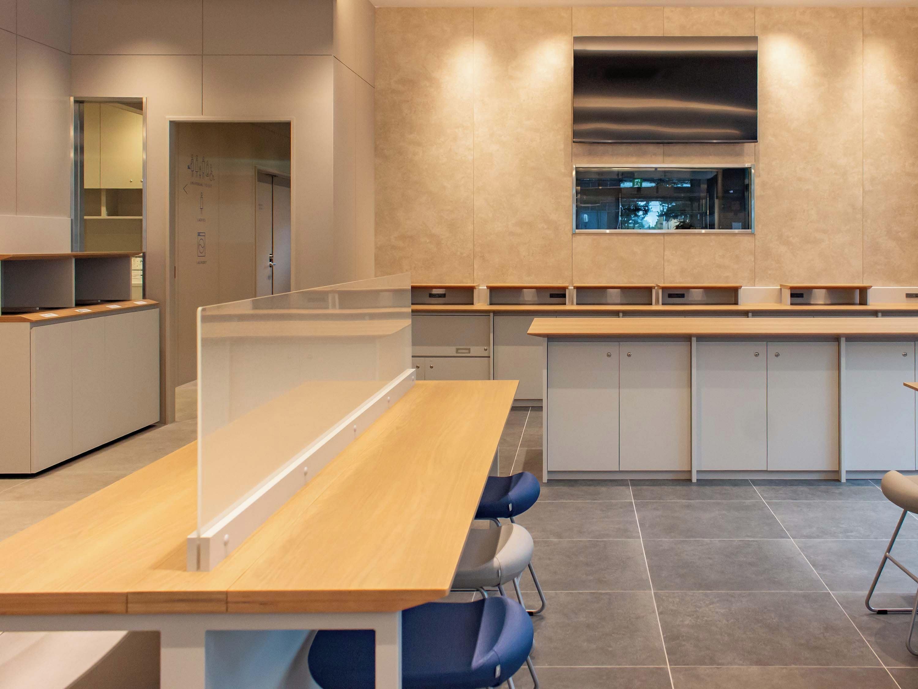 A modern kitchen with a central island, built-in cabinets, and a window above the sink.