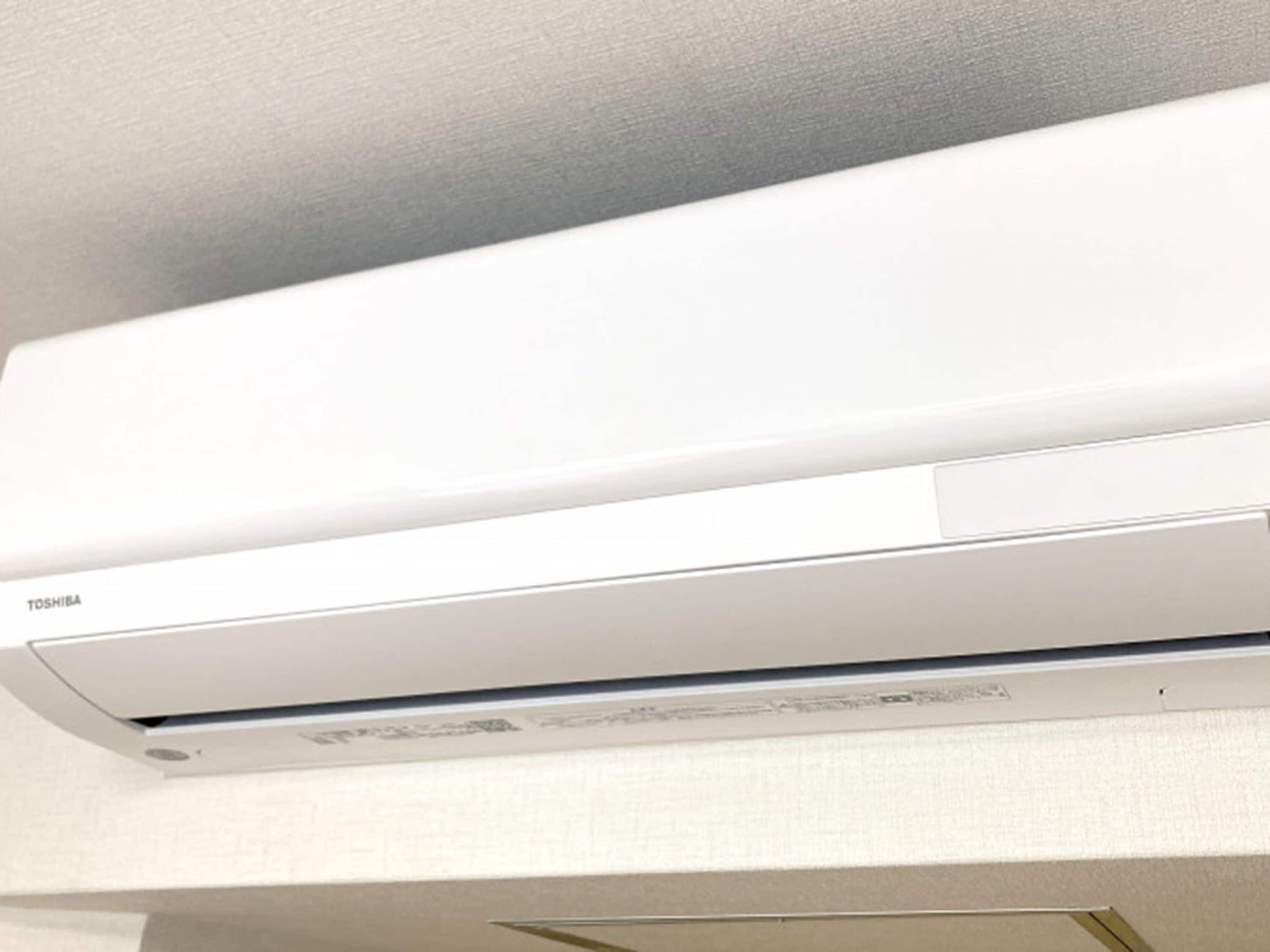 A white air conditioning unit mounted on a wall.