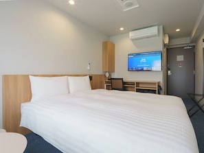 A hotel room with a large bed, a desk, a chair, and a television on the wall. - Toyoko Inn Tsukuba-eki (Tsukuba)