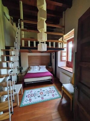 A bedroom with a bunk bed, a bedside table, a chair, a window with a view, and a radiator. - Apartment in LEKEITIO (MEDEXA)