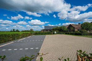 A paved parking area with a building in the background.