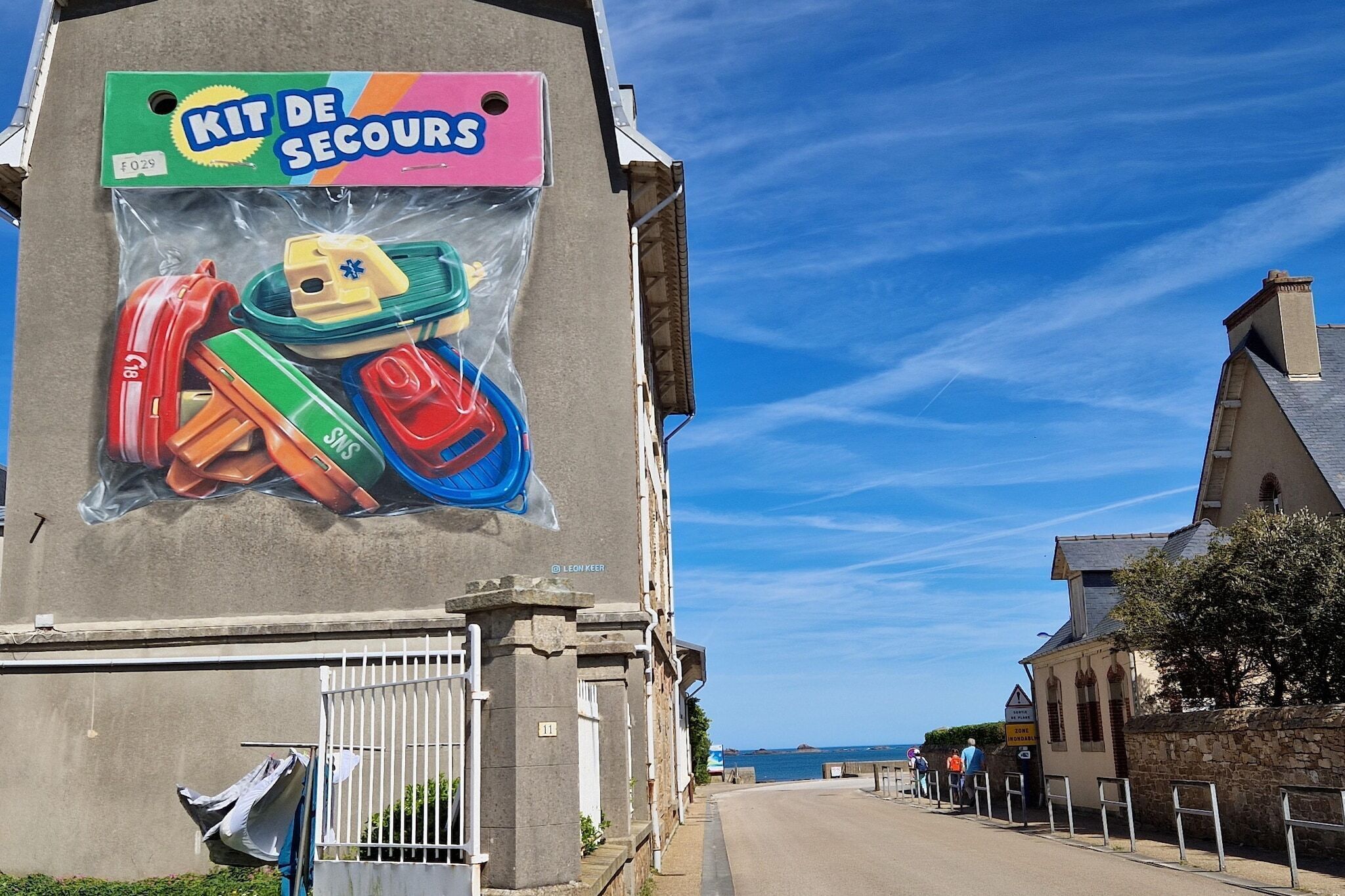 A building with a large advertisement for a travel kit.