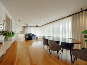 A modern living space with a dining area, kitchen, and seating area. - DOWNTOWN PENTHOUSE with RIVER VIEW by VACATIONY by Interhome (Porto)