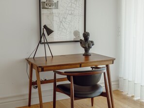 A wooden desk with a lamp and a bust sculpture. - DOWNTOWN PENTHOUSE with RIVER VIEW by VACATIONY by Interhome (Porto)