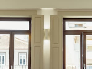 A pair of double doors with a view of buildings outside. - Apartment  by Interhome (Porto)