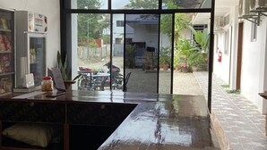 A kitchen with a large window, a refrigerator, and a counter. - Sipalay Cozy Garden Stay (Sipalay)