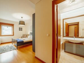 A modern bedroom with a bed, bedside table, lamp, and a window. - DOWNTOWN DELUXE 6 by VACATIONY by Interhome (Porto)