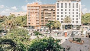 A multi-story hotel with balconies, a parking lot, and surrounding greenery. - Monlar Campanar (Valencia)