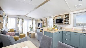 A compact living space with a dining area, kitchenette, and seating area. - Platinum 3 Pets allowed Sleeps 6 (Fishguard, Pembrokeshire)