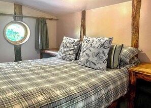 A bedroom with a bed, pillows, a window, and a wooden headboard. - Bronze Plus 3 Bed Pets Sleeps 6 (Clarach Bay, Nr Aberystwyth)