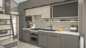 A modern kitchen with a built-in stove, oven, and microwave. There is a wooden staircase leading to an upper level. - 1 bedroom accommodation in Arrochar (Arrochar)