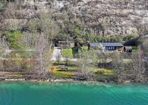 A lakeside property with a house, a dock, and a gazebo.