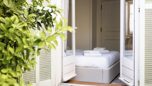 A room with a bed, a door, and a window. - Le Provence - Les Demoiselles at Versailles (Versailles)