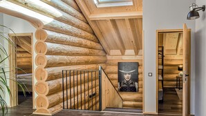 A log cabin interior with a skylight, wooden staircase, and a view into another room. - Vacation log cabin Black Forest 4 - Luxury chalet with sauna & whirlpool on the Feldberg (Feldberg (Schwarzwald))