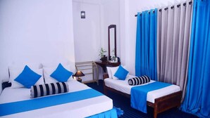 A hotel room with two beds, a nightstand, a mirror, and a window with curtains. - Travel Rest Inn (Ella)