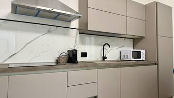 Coffee/tea maker, fridge, microwave, cookware/dishes/utensils
