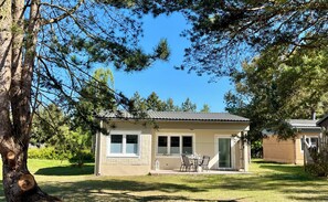 A single-story house with a patio, a covered porch, and a garage. - Relaxation near the Baltic Sea and Bodden - view of nature, with terrace and fireplace (Pruchten)