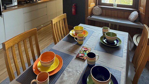 A modern kitchen with a dining area, a television, and a window with a view. - SPACIOUS 3 BEDROOM VICTORIAN FLAT IN DUNFERMLINE. VERY NEAR TOWN CENTRE ! (Dunfermline)
