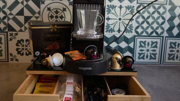 A coffee machine with a glass carafe, a box labeled 'TRUFFLES,' and a wooden drawer with various items.
