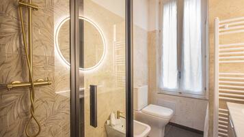 Ein Badezimmer mit Duschkabine, Toilette und Bidet.