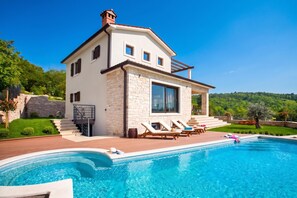 A two-story house with a swimming pool, stone facade, and a view of the surrounding greenery. - Pool Villa Royal Blue /w Panoramic Sea View (Rasa)