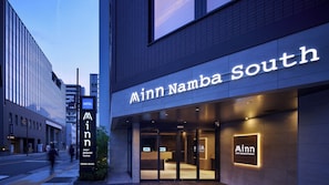 A hotel entrance with a sign reading 'Ainn Namba South' and a visible reception desk. - Minn Namba South (Osaka)