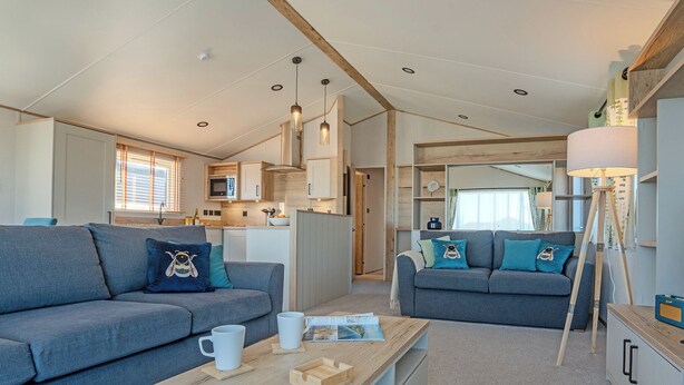 A compact living space with two sofas, a coffee table, and a lamp.