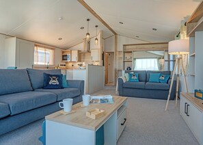 A compact living space with two sofas, a coffee table, and a lamp.