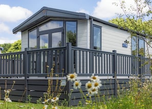 A modern, single-story building with a grey exterior, large windows, and a balcony with a railing. - 1 bedroom accommodation in Padstow (Padstow)