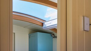 A room with a skylight, a ceiling fan, and a light switch on the wall. - 1 bedroom accommodation in Landford, Nr Salisbury (Landford, Nr Salisbury)