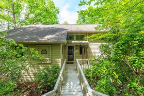 A house with a front porch, a staircase leading to the entrance, and a sign that reads 'Villa Del Monte.' - Vista Della Montagna (Lake Lure)